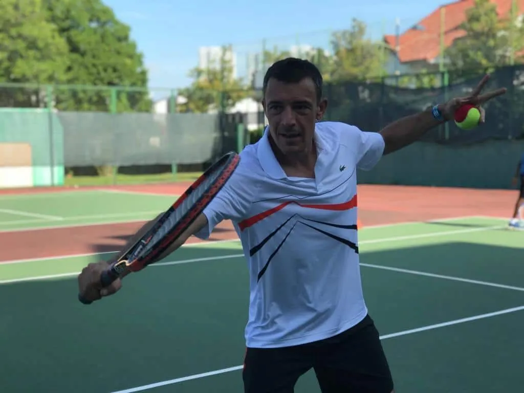 Adult player reaching for a volley during a coaching session