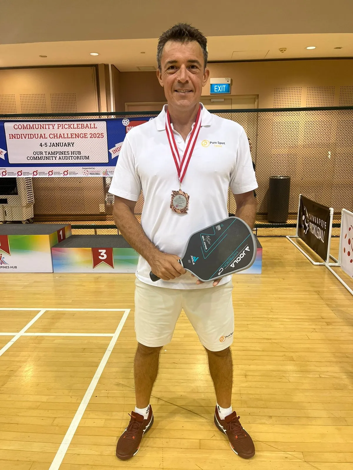 Anthony Claudot with his medal at the Community Pickleball Challenge in Singapore