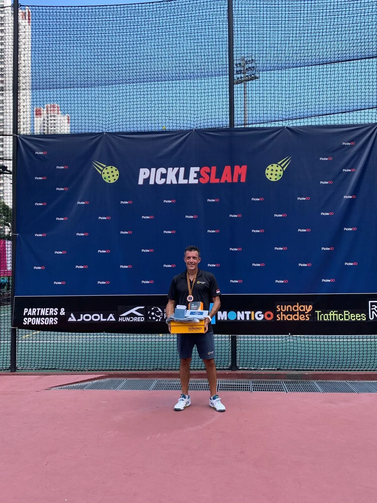 Anthony Claudot with his prize at the PickleSlam pickleball tournament